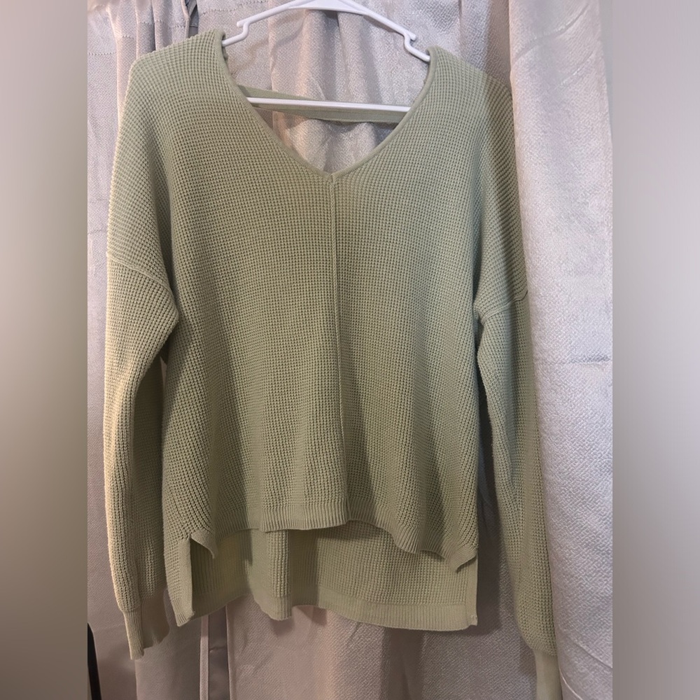V-neck light green sweater with slight open back